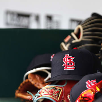 Apr 24, 2022; Cincinnati, Ohio, USA; A view of St. Louis Cardinals players    hats and gloves in the dugout during a game with the Cincinnati Reds at Great American Ball Park. Mandatory Credit: David Kohl-Imagn Images