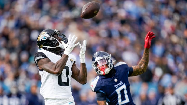 Jacksonville Jaguars wide receiver Calvin Ridley (0) receives a pass to bring in a touchdown past Tennessee Titans cornerback Sean Murphy-Bunting (0) during the second quarter at Nissan Stadium in Nashville, Tenn., Sunday, Jan. 7, 2024.