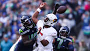 Nov 9, 2025; Seattle, Washington, USA; Arizona Cardinals quarterback Jacoby Brissett (7) fumbles the ball as Seattle Seahawks linebacker Tyrice Knight (48) defends during the second quarter at Lumen Field. Mandatory Credit: Kevin Ng-Imagn Images