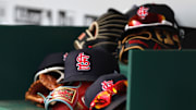 Apr 24, 2022; Cincinnati, Ohio, USA; A view of St. Louis Cardinals players    hats and gloves in the dugout during a game with the Cincinnati Reds at Great American Ball Park. Mandatory Credit: David Kohl-Imagn Images