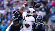 Nov 9, 2025; Seattle, Washington, USA; Arizona Cardinals quarterback Jacoby Brissett (7) fumbles the ball as Seattle Seahawks linebacker Tyrice Knight (48) defends during the second quarter at Lumen Field.