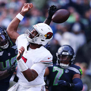 Nov 9, 2025; Seattle, Washington, USA; Arizona Cardinals quarterback Jacoby Brissett (7) fumbles the ball as Seattle Seahawks linebacker Tyrice Knight (48) defends during the second quarter at Lumen Field.