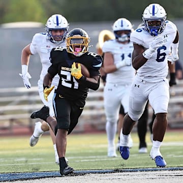 Moeller running back Dante Ware (21) carries the ball during their football game against St. Xavier Friday, Sept. 19, 2025.