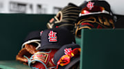 Apr 24, 2022; Cincinnati, Ohio, USA; A view of St. Louis Cardinals players    hats and gloves in the dugout during a game with the Cincinnati Reds at Great American Ball Park. Mandatory Credit: David Kohl-Imagn Images