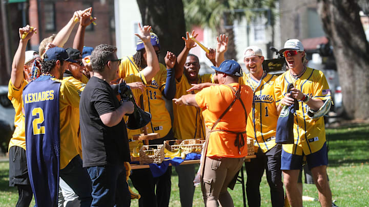 One of the food truck operators dances with Tyler Florence and players from the Savannah Bananas during the filming for the Food Network's Great Food Truck Race on Tuesday, March 11, 2025 at Emmet Park in Savannah.