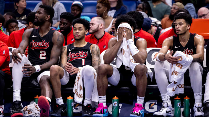 Mar 16, 2024; New Orleans, Louisiana, USA;  Portland Trail Blazers guard Anfernee Simons (1) and center Deandre Ayton (2) on the bench in the final few minutes of the game against the New Orleans Pelicans during the second half at Smoothie King Center. Mandatory Credit: Stephen Lew-USA TODAY Sports