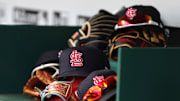 Apr 24, 2022; Cincinnati, Ohio, USA; A view of St. Louis Cardinals players    hats and gloves in the dugout during a game with the Cincinnati Reds at Great American Ball Park. Mandatory Credit: David Kohl-Imagn Images