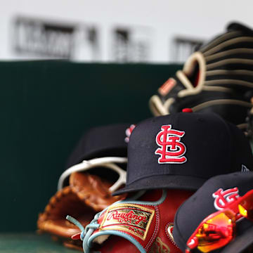 Apr 24, 2022; Cincinnati, Ohio, USA; A view of St. Louis Cardinals players    hats and gloves in the dugout during a game with the Cincinnati Reds at Great American Ball Park. Mandatory Credit: David Kohl-Imagn Images