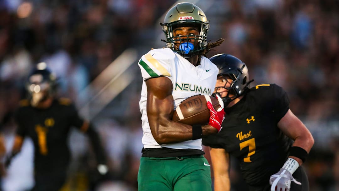 Neumann Celtics receiver Jayden Petit runs after making a catch.