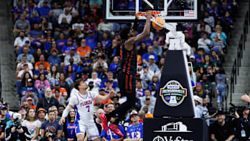 Nov 16, 2025; Jacksonville, Florida, USA; Miami Hurricanes forward Timotej Malovec (88) dunks the ball over Florida Gators guard Urban Klavzar (7) during the first half at VyStar Veterans Memorial Arena. Mandatory Credit: Matt Pendleton-Imagn Images
