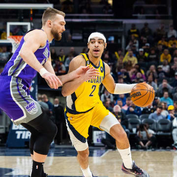 Feb 3, 2023; Indianapolis, Indiana, USA; Indiana Pacers guard Andrew Nembhard (2) dribbles the ball while Sacramento Kings forward Domantas Sabonis (10)  defends in the first quarter at Gainbridge Fieldhouse. Mandatory Credit: Trevor Ruszkowski-USA TODAY Sports