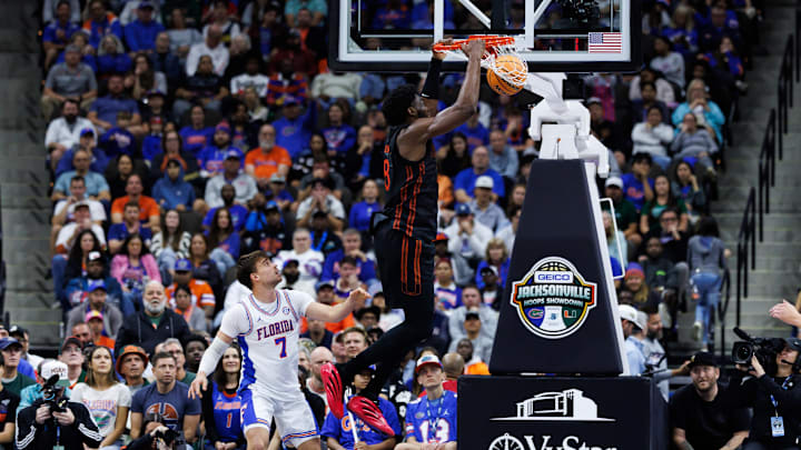 Nov 16, 2025; Jacksonville, Florida, USA; Miami Hurricanes forward Timotej Malovec (88) dunks the ball over Florida Gators guard Urban Klavzar (7) during the first half at VyStar Veterans Memorial Arena. Mandatory Credit: Matt Pendleton-Imagn Images