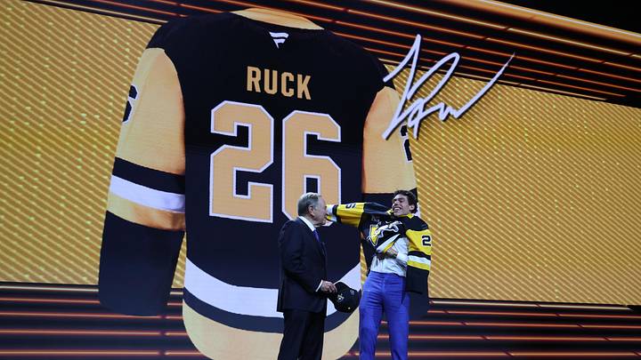 Jun 26, 2026; Buffalo, New York, USA; Liam Ruck reacts beside NHL commissioner Gary Bettman after being selected with the twenty second pick in the first round of the 2026 NHL Draft by the Pittsburgh Penguins at KeyBank Center. Mandatory Credit: Timothy T. Ludwig-Imagn Images