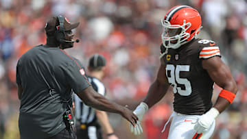 Cleveland Browns defensive line coach Jacques Cesaire, left, celebrates with defensive end Myles Garrett (95) during the first half of an NFL football game at Huntington Bank Field, Sunday, Sept. 22, 2024, in Cleveland, Ohio.