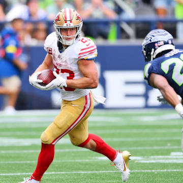 Sep 7, 2025; Seattle, Washington, USA; San Francisco 49ers running back Christian McCaffrey (23) runs the ball after a catch during the second half against the Seattle Seahawks at Lumen Field. Mandatory Credit: Steven Bisig-Imagn Images