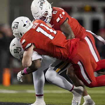 Oct 25, 2025; Cincinnati, Ohio, USA;  Baylor Bears tight end Michael Trigg (1) is unable to hold on to a catch as he is tackled by Cincinnati Bearcats linebacker Jake Golday (11) and defensive back Tre Gola-Callard (6) in the second half at Nippert Stadium. Mandatory Credit: Aaron Doster-Imagn Images