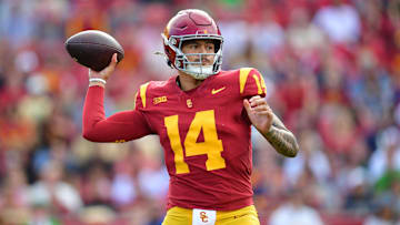 Nov 30, 2024; Los Angeles, California, USA; Southern California Trojans quarterback Jayden Maiava (14) throws against the Notre Dame Fighting Irish during the first half at the Los Angeles Memorial Coliseum. Mandatory Credit: Gary A. Vasquez-Imagn Images