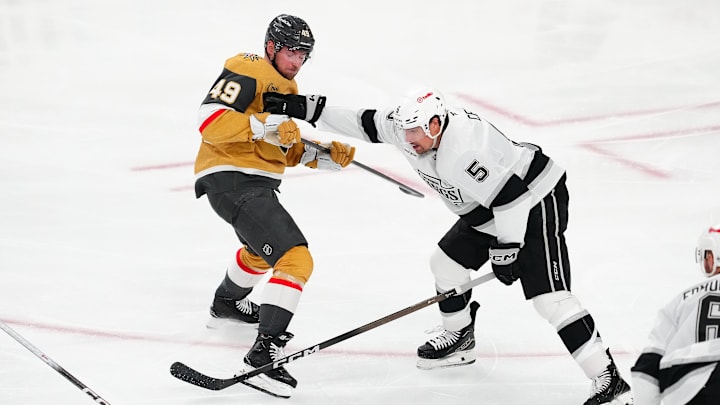 Feb 5, 2026; Las Vegas, Nevada, USA; Los Angeles Kings defenseman Cody Ceci (5) checks Vegas Golden Knights left wing Ivan Barbashev (49) during the third period at T-Mobile Arena. Mandatory Credit: Stephen R. Sylvanie-Imagn Images