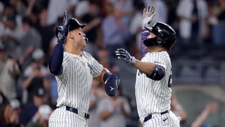 Yankees designated hitter Giancarlo Stanton celebrates his two-run home run against the Twins with center fielder Aaron Judge.