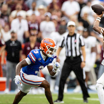 Sep 14, 2024; Gainesville, Florida, USA; Texas A&M Aggies quarterback Marcel Reed (10) throws the ball under pressure from Florida Gators defensive back Jason Marshall Jr. (3) during the first half at Ben Hill Griffin Stadium. Mandatory Credit: Matt Pendleton-Imagn Images