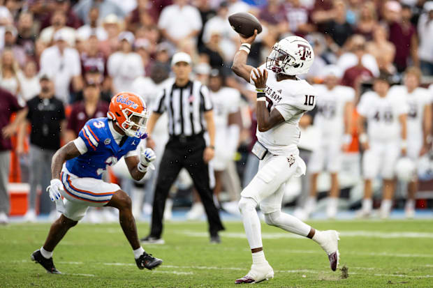 Texas A&M Aggies quarterback Marcel Reed throws the ball under pressure from Florida Gators defensive back Jason Marshall Jr.