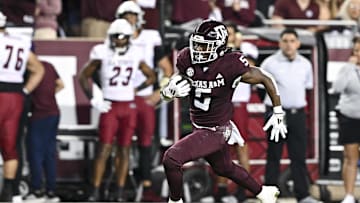 Nov 16, 2024; College Station, Texas, USA; Texas A&M Aggies running back Amari Daniels (5) runs the ball during the first half against the New Mexico State Aggies at Kyle Field. Mandatory Credit: Maria Lysaker-Imagn Images 