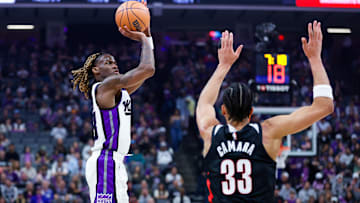 Mar 17, 2025; Sacramento, California, USA; Sacramento Kings guard Keon Ellis (23) shoots against Portland Trail Blazers forward Toumani Camara (33) during the first quarter at Golden 1 Center. Mandatory Credit: Sergio Estrada-Imagn Images