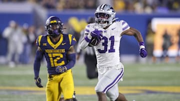 Oct 19, 2024; Morgantown, West Virginia, USA; Kansas State Wildcats running back DJ Giddens (31) runs after a catch during the third quarter against the West Virginia Mountaineers at Mountaineer Field at Milan Puskar Stadium. Mandatory Credit: Ben Queen-Imagn Images