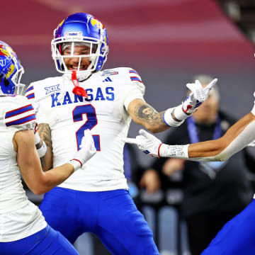 Dec 26, 2023; Phoenix, AZ, USA; Kansas Jayhawks wide receiver Lawrence Arnold (2) celebrates with wide receiver Luke Grimm (11) and wide receiver Quentin Skinner (0) during the second half against the UNLV Rebels in the Guaranteed Rate Bowl at Chase Field. 