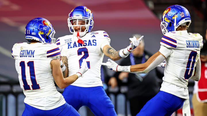 Dec 26, 2023; Phoenix, AZ, USA; Kansas Jayhawks wide receiver Lawrence Arnold (2) celebrates with wide receiver Luke Grimm (11) and wide receiver Quentin Skinner (0) during the second half against the UNLV Rebels in the Guaranteed Rate Bowl at Chase Field. 