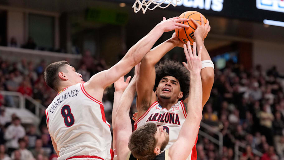 Arizona Wildcats forward Ivan Kharchenkov and forward Koa Peat battle Purdue Boilermakers center Oscar Cluff on the glass.