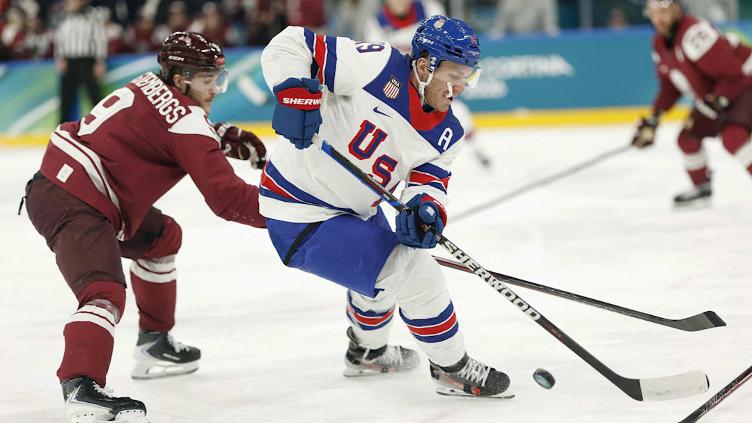 Feb 12, 2026; Milan, Italy; Matthew Tkachuk of United States in action with Renars Krastenbergs of Latvia in men's ice hockey group C play during the Milano Cortina 2026 Olympic Winter Games at Milano Santagiulia Ice Hockey Arena. Mandatory Credit: Geoff Burke-Imagn Images Feb 12, 2026; Milan, Italy; Matthew Tkachuk of United States in action with Renars Krastenbergs of Latvia in men's ice hockey group C play during the Milano Cortina 2026 Olympic Winter Games at Milano Santagiulia Ice Hockey Arena. Mandatory Credit: Geoff Burke-Imagn Images