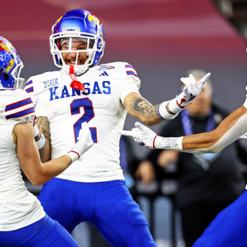 Dec 26, 2023; Phoenix, AZ, USA; Kansas Jayhawks wide receiver Lawrence Arnold (2) celebrates with wide receiver Luke Grimm (11) and wide receiver Quentin Skinner (0) during the second half against the UNLV Rebels in the Guaranteed Rate Bowl at Chase Field. Mandatory Credit: Mark J. Rebilas-USA TODAY Sports