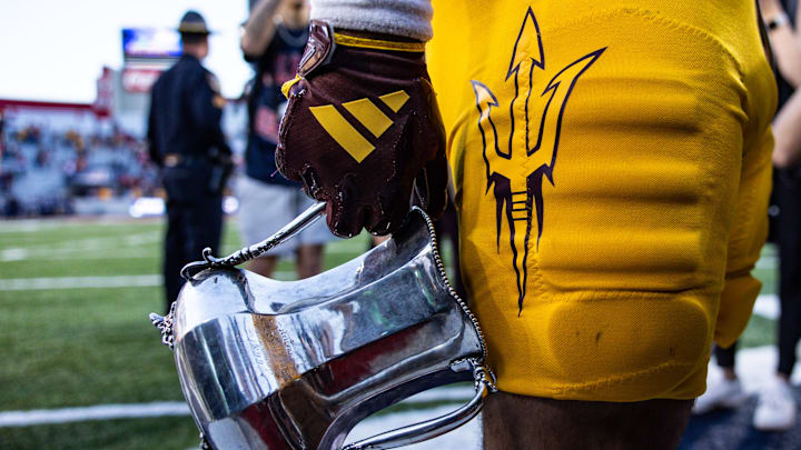 Nov 30, 2024; Tucson, Arizona, USA; Arizona State Sun Devils running back Cam Skattebo (4) holds the Territorial Cup at the end of the game against the Arizona Wildcats at Arizona Stadium. Mandatory Credit: Aryanna Frank-Imagn Images
