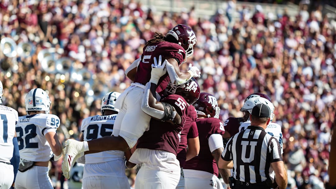Texas A&M Aggies running back Amari Daniels (5) is lift into the air by offensive lineman Ar'maj Reed-Adams (55) in the first half of a game against the Samford Bulldogs at Kyle Field. 