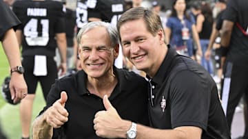 Oct 26, 2024; College Station, Texas, USA; Texas Governer Greg Abbott, left, and Texas A&M Athletic Director Trev Alberts pose for pictures prior to the game against the LSU Tigers. The Aggies defeated the Tigers 38-23; at Kyle Field. Mandatory Credit: Maria Lysaker-Imagn Images.  