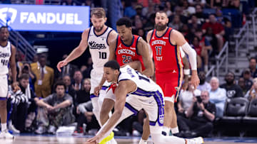Apr 19, 2024; New Orleans, Louisiana, USA;  Sacramento Kings forward Keegan Murray (13) reaches for a loose ball against New Orleans Pelicans guard Trey Murphy III (25) in the first half during a play-in game of the 2024 NBA playoffs at Smoothie King Center. Mandatory Credit: Stephen Lew-Imagn Images