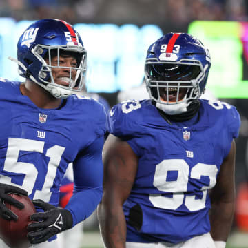 Jan 7, 2024; East Rutherford, New Jersey, USA; New York Giants linebacker Azeez Ojulari (51) celebrates with defensive tackle Rakeem Nunez-Roches (93) after recovering a fumble during the second half against the Philadelphia Eagles at MetLife Stadium. Mandatory Credit: Vincent Carchietta-USA TODAY Sports