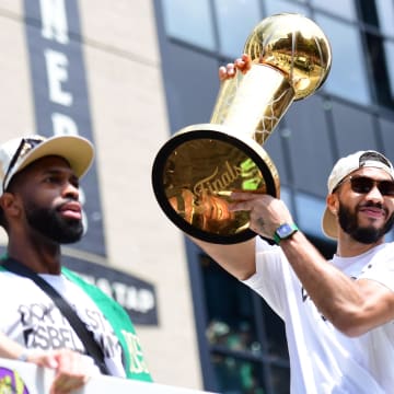 Jun 21, 2024; Boston, MA, USA;  Boston Celtics player Jayson Tatum holds the Larry OíBrien trophy during the Boston Celtics Championship parade. Mandatory Credit: Bob DeChiara-USA TODAY Sports