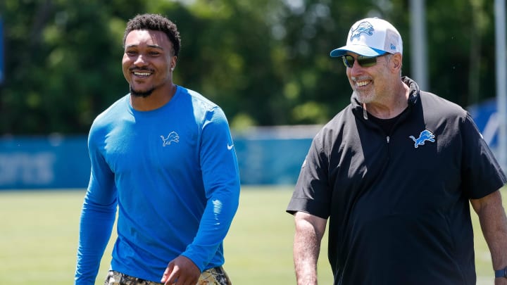 Detroit Lions safety Brian Branch (32) talks to Director of Sports Performance Mike Clark after practice during OTAs at Detroit Lions headquarters and training facility in Allen Park on Thursday, May 30, 2024.