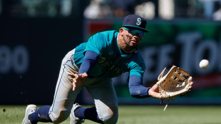 Seattle Mariners left fielder Jonatan Clase (5) dives for a fly ball in the sixth inning against the Colorado Rockies at Coors Field in April.