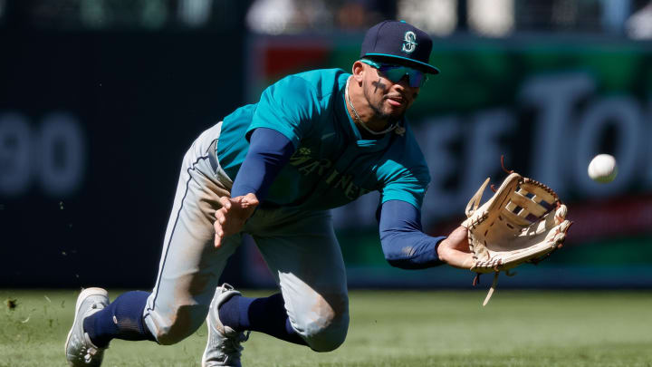 Seattle Mariners left fielder Jonatan Clase dives for a fly ball against the Colorado Rockies in April at Coors Field in Denver.