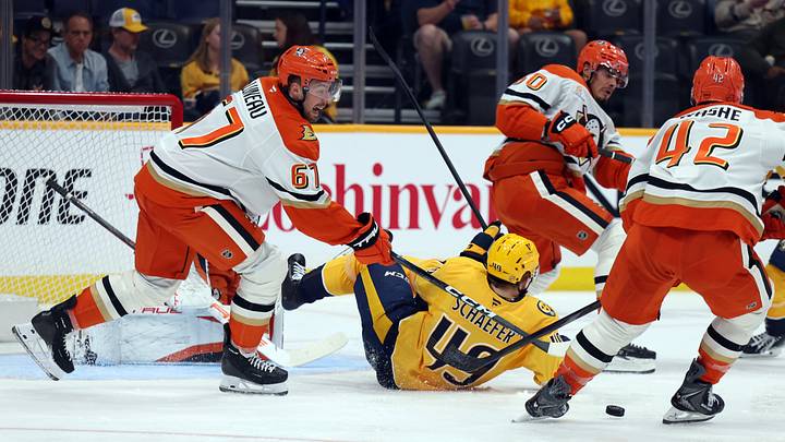 Apr 16, 2026; Nashville, Tennessee, USA; Anaheim Ducks defenseman Tristan Luneau (67) and center Tim Washe (42) defend against an attack by Nashville Predators left wing Reid Schaefer (49) during the second period of their game at Bridgestone Arena. Mandatory Credit: Alan Poizner-Imagn Images