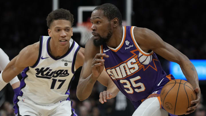 Feb 13, 2024; Phoenix, Arizona, USA; Phoenix Suns forward Kevin Durant (35) drives on Sacramento Kings forward Kessler Edwards (17)  in the first half at Footprint Center. Mandatory Credit: Rick Scuteri-USA TODAY Sports