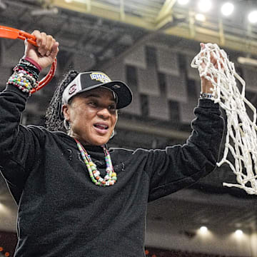 South Carolina coach Dawn Staley cuts down the nets after the team won the SEC.