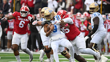 Oct 25, 2025; Bloomington, Indiana, USA; Indiana Hoosiers defensive lineman Tyrique Tucker (95) brings down UCLA Bruins quarterback Nico Iamaleava (9) during the first half at Memorial Stadium. Mandatory Credit: Robert Goddin-Imagn Images