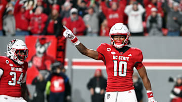 Nov 25, 2023; Raleigh, North Carolina, USA; North Carolina State Wolfpack receiver KC Concepcion (10) reacts after scoring a touchdown against the North Carolina Tar Heels during the first half at Carter-Finley Stadium. Mandatory Credit: Rob Kinnan-Imagn Images