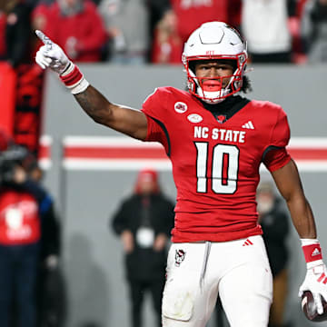 Nov 25, 2023; Raleigh, North Carolina, USA; North Carolina State Wolfpack receiver KC Concepcion (10) reacts after scoring a touchdown against the North Carolina Tar Heels during the first half at Carter-Finley Stadium. Mandatory Credit: Rob Kinnan-Imagn Images