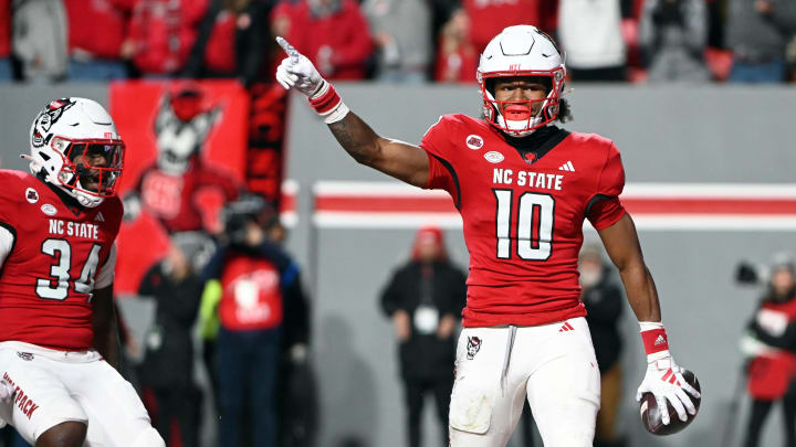 Nov 25, 2023; Raleigh, North Carolina, USA; North Carolina State Wolfpack receiver KC Concepcion (10) reacts after scoring a touchdown against the North Carolina Tar Heels during the first half at Carter-Finley Stadium.