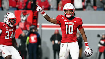Nov 25, 2023; Raleigh, North Carolina, USA; North Carolina State Wolfpack receiver KC Concepcion (10) reacts after scoring a touchdown against the North Carolina Tar Heels during the first half at Carter-Finley Stadium. Mandatory Credit: Rob Kinnan-Imagn Images
